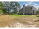Expansive backyard with a well-maintained lawn, mature trees, and ample space for outdoor activities and recreation at 115 Baystone Dr, Sanford, NC 27332