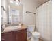 The bathroom has a modern vanity with a single sink and a shower with neutral-toned curtain at 115 Baystone Dr, Sanford, NC 27332