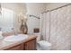 Cozy bathroom with floral shower curtain, dark wood vanity, and stylish accents at 115 Baystone Dr, Sanford, NC 27332