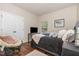 Cozy bedroom with hardwood floors, a comfortable bed, and a papasan chair near the closet at 115 Baystone Dr, Sanford, NC 27332