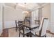 Elegant dining room with a wood table, wainscoting, and coffered ceiling at 115 Baystone Dr, Sanford, NC 27332