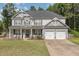 Charming two-story home with a welcoming front porch and a two-car garage at 115 Baystone Dr, Sanford, NC 27332