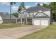 Attractive two-story home with a front porch and a two-car garage in a leafy neighborhood at 115 Baystone Dr, Sanford, NC 27332