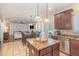 Open kitchen and dining area with stainless steel refrigerator and backyard access at 115 Baystone Dr, Sanford, NC 27332
