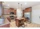 Spacious kitchen with granite countertops, tile flooring, and stainless steel refrigerator at 115 Baystone Dr, Sanford, NC 27332