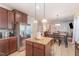 Open kitchen area with granite countertops and view into dining and living room at 115 Baystone Dr, Sanford, NC 27332