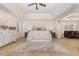 Spacious main bedroom boasting trey ceilings, sitting area, and a cozy rug, creating a luxurious retreat at 115 Baystone Dr, Sanford, NC 27332