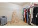 Walk-in closet with built-in shelving and ample hanging space for wardrobe storage, including formal wear at 115 Baystone Dr, Sanford, NC 27332