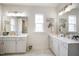 Bright bathroom with double sinks and mirrors reflecting the shower and toilet rooms at 1213 Remey Ave, Wake Forest, NC 27587