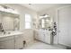 Bathroom featuring bright lighting, double sinks, and a glass-doored shower at 1213 Remey Ave, Wake Forest, NC 27587