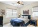 This bedroom boasts natural light, a ceiling fan, and simple decor at 1213 Remey Ave, Wake Forest, NC 27587