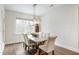 Elegant dining room with a modern chandelier, seating for six, and a large window for natural light at 1213 Remey Ave, Wake Forest, NC 27587