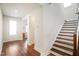 Bright foyer featuring hardwood floors and a staircase leading to the upper level of the house at 1213 Remey Ave, Wake Forest, NC 27587