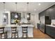 Well-appointed kitchen with dark cabinetry, a center island with seating, and stainless steel appliances at 1213 Remey Ave, Wake Forest, NC 27587