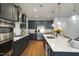 Spacious kitchen with a large island, dark cabinets, and stainless steel appliances at 1213 Remey Ave, Wake Forest, NC 27587