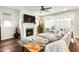 Cozy living room with a fireplace, large sofa, and access to an outdoor space at 1213 Remey Ave, Wake Forest, NC 27587
