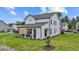 Well-maintained backyard with green lawn and a covered patio at 134 Favored Avenue, Sanford, NC 27330