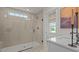 This bathroom is equipped with a glass enclosed shower with neutral tile and quartz countertop at 134 Favored Avenue, Sanford, NC 27330