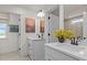 The bathroom boasts double sinks, framed mirrors, modern lighting fixtures and views to the lush green outdoors at 134 Favored Avenue, Sanford, NC 27330