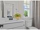 Bright bathroom with a white vanity, black fixtures, and a window view to the outside at 134 Favored Avenue, Sanford, NC 27330