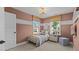 Bedroom with pink walls, two windows with woven shades, and a white stripe detail at 134 Favored Avenue, Sanford, NC 27330