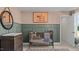 Bedroom with wainscoting, neutral walls, a decorative mobile, and an equestrian themed painting at 134 Favored Avenue, Sanford, NC 27330