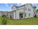 View of the backyard with a covered patio area and lush green lawn at 134 Favored Avenue, Sanford, NC 27330