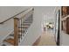 Bright foyer with wood stairs, neutral walls, and hardwood flooring leading into an open-concept living space at 134 Favored Avenue, Sanford, NC 27330