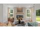 Living room features fireplace, large windows with natural light, and neutral color palette at 134 Favored Avenue, Sanford, NC 27330