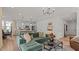 Stylish open-concept living area featuring a green sofa, modern lighting and access to kitchen at 134 Favored Avenue, Sanford, NC 27330