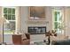 Living room features fireplace, large windows with natural light, and neutral color palette at 134 Favored Avenue, Sanford, NC 27330