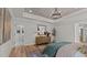 This main bedroom features an elegant chandelier, wood floors, and is decorated with a light neutral color palette at 134 Favored Avenue, Sanford, NC 27330
