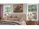 Bedroom with tray ceilings, hardwood floors, neutral walls and two bedside tables at 134 Favored Avenue, Sanford, NC 27330