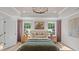 This main bedroom boasts lots of natural light, decorative pillows, wood floors, and a light neutral color palette at 134 Favored Avenue, Sanford, NC 27330