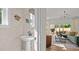 Powder room featuring pedestal sink with oval mirror, accented with decorative hand towels at 134 Favored Avenue, Sanford, NC 27330