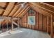 Unfinished attic space with exposed wood beams, a window, and ample potential at 201 N Us 301, Micro, NC 27555