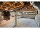 Unfinished basement with concrete floor, exposed pipes and block walls at 201 N Us 301, Micro, NC 27555