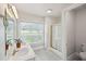 Bright bathroom features a double sink vanity, and a tiled walk-in shower at 201 N Us 301, Micro, NC 27555