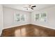Bedroom with hardwood floors, two windows and a ceiling fan at 201 N Us 301, Micro, NC 27555