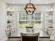 Dining room featuring a large table with a modern light fixture and built-in shelves at 201 N Us 301, Micro, NC 27555