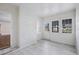 Bright sunroom entrance featuring white brick, trim, and windows, with hardwood-look flooring at 201 N Us 301, Micro, NC 27555