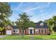 Charming single-story brick home with manicured lawn, flowerbeds, and inviting front entrance at 201 N Us 301, Micro, NC 27555