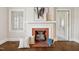 Close-up of a brick fireplace with wood logs, pillows, and decorative accents at 201 N Us 301, Micro, NC 27555