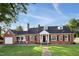 Charming brick home with a well-manicured lawn, black shutters, and a welcoming entrance at 201 N Us 301, Micro, NC 27555