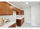 Bright kitchen featuring white counters, wood cabinets, and wood-look tile flooring at 201 N Us 301, Micro, NC 27555