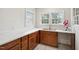 Kitchen featuring wood cabinets, a stainless steel sink, and bright natural light at 201 N Us 301, Micro, NC 27555
