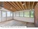 Enclosed sunroom with light wood floors, open rafters, and lots of natural light at 201 N Us 301, Micro, NC 27555