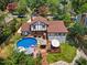 Aerial view of a home with a backyard featuring a large in-ground pool, deck, and manicured lawn at 2020 Port Royal Rd, Raleigh, NC 27609
