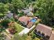 Aerial view of a home with a large backyard, mature trees, a swimming pool, and a patio at 2020 Port Royal Rd, Raleigh, NC 27609