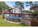 Backyard with pool, deck, lush greenery, and home exterior, perfect for outdoor activities at 2020 Port Royal Rd, Raleigh, NC 27609